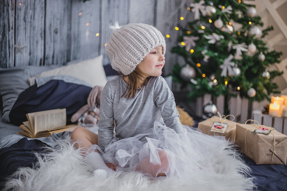 Baby Girl Next To The Christmace Tree - Atelier Kids Childcare Centre Blog - 5 Success Tips for Managing the Holidays